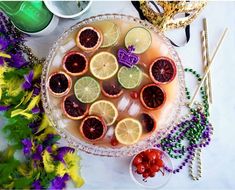 a platter filled with lemons, grapefruit and raspberry slices