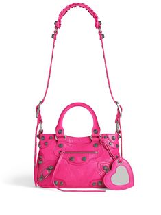 This small tote handbag from Balenciaga is perfect for any fashion-forward woman Featuring a vibrant fuchsia pink color, this bag is sure to make a statement Made with high-quality lambskin leather and accented with silver-tone hardware for a touch of luxury The decorative zip detailing adds a unique touch to this bag Comes with a mirror tag, two rolled top handles, and adjustable detachable shoulder strap for versatile carrying options The top zip fastening and spacious main compartment ensure Balenciaga Women, Balenciaga Bag, Chic Handbags, Strap Top, Fuchsia Pink, Small Tote, Womens Fall, Lambskin Leather, Pink Bag