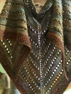 a close up of a knitted shawl on a mannequin headdress