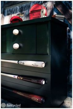 a black dresser with baseballs on it and a red fire hydrant in the background