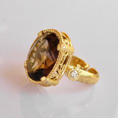 Smokey Quartz & Diamond Ring in 18k Solid Gold, This beauty is part of our exclusive a one of a Kind creation collection * 18k solid Gold * Pristine natural 1x1.8cm faceted Oval Smokey Quartz Gemstone * 2 Vs si Brilliant quality 0.3ct Diamonds * All our Stones are Ethically sourced. * Size adjustment from 5us to 8 us Included * Price includes shipping * Custom duty charges are regulated by your country upon delivery. There is no custom duty charges for all orders delivered to the EU countries. * For time sensitive orders please let us know and we will do our best to accommodate you Custom orders Welcomed! Luxury Oval Topaz Ring, Luxury Yellow Gold Topaz Ring With Diamond Accents, Elegant 14k Gold Diamond Cut Topaz Ring, Luxury 14k Gold Topaz Ring, Luxury Yellow Gold Oval Topaz Ring, Luxury Oval Yellow Gold Topaz Ring, Luxury Yellow Gold Topaz Ring With Diamond, Luxury Oval Diamond Topaz Ring, Luxury Topaz And Diamond Open Ring