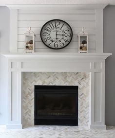 a white fireplace with a clock above it