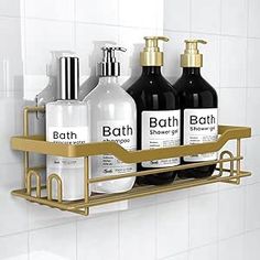 a bathroom shelf with three bottles and two soap dispensers