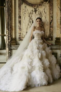 a woman in a wedding dress posing for the camera