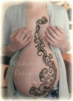 a pregnant woman with henna tattoos on her belly and the words wishcraft designs