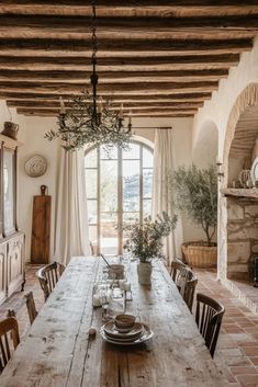 a dining room table with chairs and a potted plant