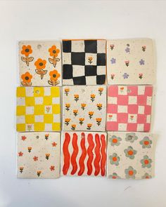 six squares with flowers and checkered designs are arranged on a white surface, one has an orange flower in the center