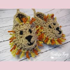 a pair of crocheted slippers with an animal face on the front and bottom