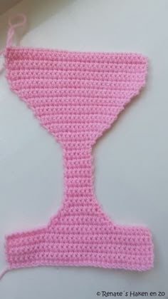 a crocheted pink object is hanging on a hook