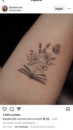 a tattoo with flowers and butterflies on the back of a woman's left arm