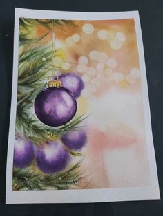 an ornament hanging from a christmas tree with purple baubles on it