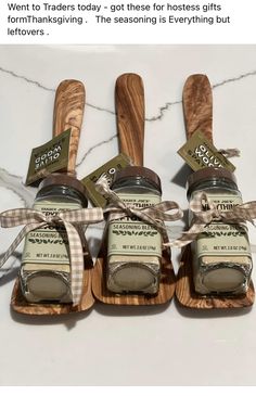 three wooden spoons and two jars with labels on them