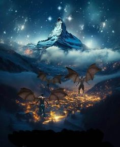 two people standing on top of a mountain with bats flying over them in the sky