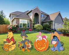 winnie the pooh and friends yard decorations in front of a house with pumpkins