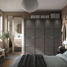 a bedroom with dark gray cabinets and white lights on the ceiling, along with a large bed