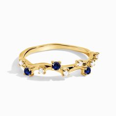 a gold ring with blue and white stones