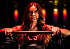 a woman is posing with a bar in front of her