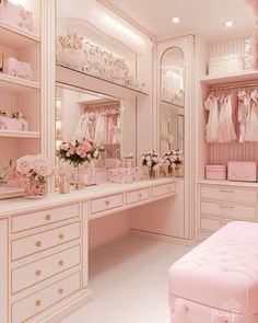 a dressing room filled with lots of pink furniture and flowers on top of the dressers