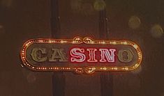 a casino sign is lit up in red and yellow lights with the word casino on it