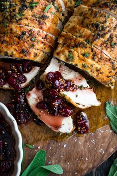 sliced chicken breast with cranberry sauce and herbs