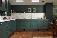 a kitchen with blue cabinets and wooden floors