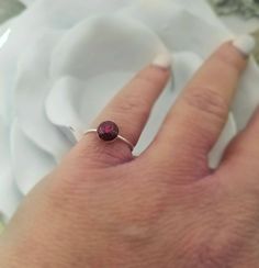 a person's hand with a ring on it