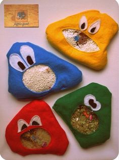 four different colored bags with eyes and noses on top of each other, one has food in it