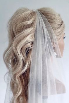 a woman with blonde hair wearing a veil