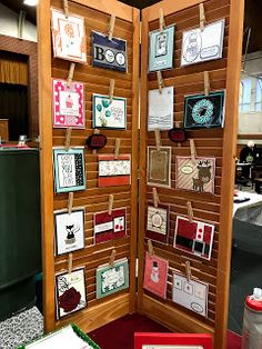 a room divider with pictures and cards on it