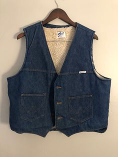 "The perfect XL denim vest with faux shearling lining. From Wrangler.  Condition: Bit of fading around edges, presents well. Measurements: Shoulder: 16\" Bust: 48\" Length: 24\"" Medium Wash Denim Vest For Winter, Winter Medium Wash Washed Denim Vest, Winter Dark Wash Cotton Denim Vest, Sleeveless Cotton Denim Vest For Winter, Vintage Denim Vest In Medium Wash For Winter, Vest Outfits, Denim Vest, Gender Neutral, Adult Outfits