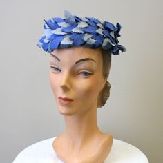 "Vintage 1950s blue wool pillbox hat, with layers of leaf appliques.  The crown is 3\" tall and the interior circumference is 20.25\".  In good condition -- with no stains.  There are a few missing leaves, but it is hard to tell. ---> If you need an order shipped by a particular date or shipped via a quicker method, please ask PRIOR to purchase to see if we can accommodate that request. Visit the rest of our shop for more goodies ---> https://www.etsy.com/shop/BlackbirdAntiquesNC Visit our shop policies page for sizing info, shipping guidelines, and more ---> https://www.etsy.com/shop/BlackbirdAntiquesNC/policy Find us on Instagram @blackbirdantiquesnc or Facebook ---> https://www.facebook.com/blackbirdgirlsvintage or Pinterest ---> https://www.pinterest.com/4and20/" Navy Fascinator, Veil Dress, Sewing Tape Measure, Blue Fascinator, Pink Cardigan Sweater, Navy Hats, Blue Cocktails, Tea Party Hats, Fur Wrap