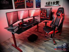 a computer desk with three monitors and two keyboards on top of it in front of posters