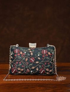 This is one of a kind handcrafted bag which is handcrafted to order. As it is a handcrafted product, it may have slight irregularities or imperfections.  MEASUREMENTS Length - 15.24cm Width - 19.30cm Handle - 58.42cm This clutch can be worn as a crossbody bag or a shoulder bag with the sling chain or can simply be carried in hand. It is spacious enough to carry mobile phones, cosmetics, keys and other small accessories. It's a beautiful ornamented piece to carry to weddings, parties and other fo Silk Clutch, Silk Gifts, Embroidered Handbag, Handcrafted Bags, Simply Be, Black Hand, Ribbon Embroidery, Evening Clutch, Small Accessories