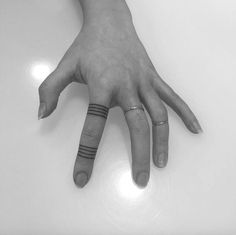 a person's hand with two rings on it