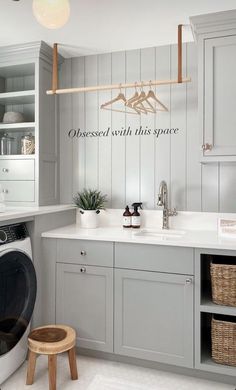 a laundry room with a washer and dryer next to it on the wall