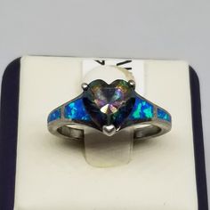 Vintage Vancaro Sterling with Opal and Mystic Topaz Ring, Size 6, Damaged. Topaz has chips and a deep scratch across most of it's surface. Marked Vancaro S925 inside band. Topaz is 8 x 8mm. Ring is 9mm wide. Weighs 0.09 ozt. We do not check prongs for wear or stones for looseness. All items are sold as is-noting that we are a resale shop so everything here had a previous owner! We will include flaws in the description when noted. This is one of the reasons our items are more affordable than new at a jewelry store. Are these stones real or fake? Aside from diamonds, we do not know if any gemstones are natural or synthetic. We will state on certain gemstones, that we know 100%, if they are created or fake due to their lack of inclusions. For this reason, we do not sell any diamonds without i Iridescent Promise Ring With Accent Stones, Iridescent Spiritual Rings For Anniversary, Iridescent Jewelry With Accent Stones For Anniversary, Iridescent Multi-stone Ring For Anniversary, Iridescent Multi-stone Anniversary Rings, Mystic Topaz Ring, European Jewelry, Vintage Fine Jewelry, Star Sapphire