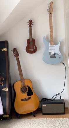 guitars and amps are lined up against the wall