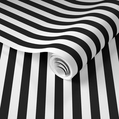 a black and white striped wallpaper with an abstract design on the bottom half of it