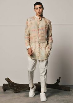 Patchwork print shirt style mal cotton kurta featuring a mandarin collar, cuffed sleeves and a curved hemline. This is a 2 piece set complete with a cream trouser style cotton pajama. Cotton Kurta With Set-in Sleeves For Eid, Spring Bandhgala With Chikankari Embroidery And Long Sleeves, Spring Long Sleeve Bandhgala With Chikankari Embroidery, Long Sleeve Cotton Bandhgala For Eid, Summer Cotton Silk Long Sleeve Sets, Cotton Kurta With Stand Collar And Placket, Semi-formal Long Sleeve Kurta With Chikankari Embroidery, Festive Cotton Bandhgala With Long Sleeves, Traditional Cotton Kurta With Stand Collar