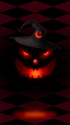 a halloween pumpkin with a witch hat on it's head and eyes glowing in the dark