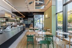 the interior of a restaurant with tables and chairs