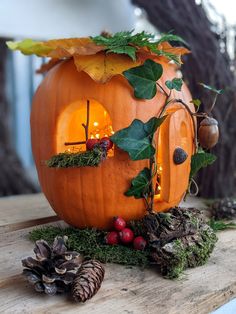 a pumpkin shaped like a house with lights inside