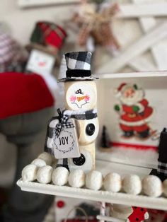 a snowman made out of marshmallows sitting on top of a shelf