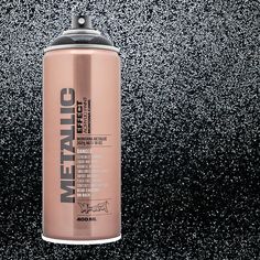 a can of metallic paint on a black background