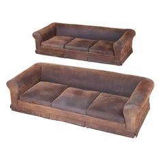 two brown leather couches sitting next to each other