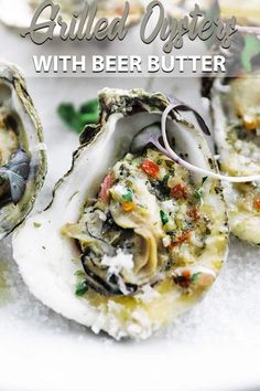 three oysters with beer and herbs on a white plate in front of the caption, grilled oysters with beer