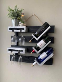 the wine rack is made out of wooden planks and holds several bottles of wine