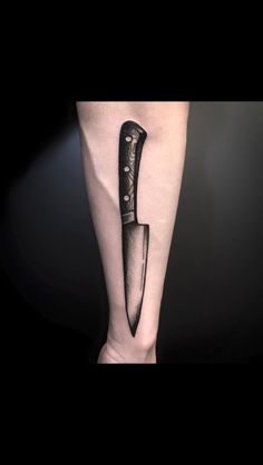 a knife tattoo on the leg