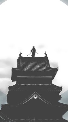 the silhouette of a person standing on top of a building with a full moon in the background