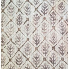 an upholstered fabric with leaves and squares in brown, white and beige colors